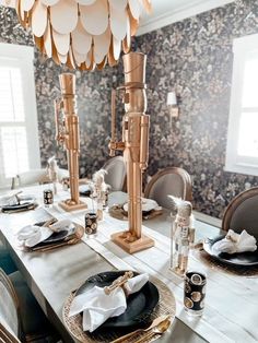 a dining room table with plates and napkins on it