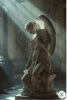 an angel statue with its wings spread out in front of the light coming from behind it