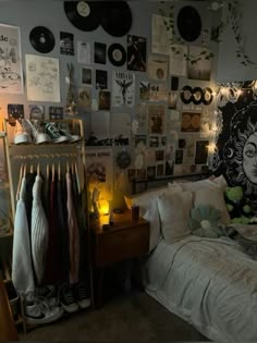 a bed room with a neatly made bed and lots of pictures on the wall