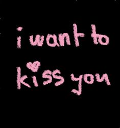 the words i want to kiss you are written in pink ink on a black background