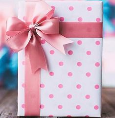 a white box with pink polka dots and a bow