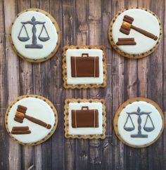 four cookies decorated with law symbols on top of a wooden table