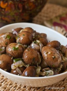 a white bowl filled with meatballs and onions