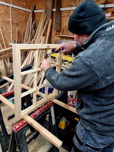 a man working on some wood in a shop