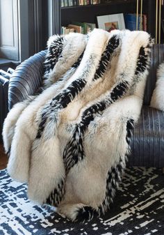 Aaaaaaahhhhhh - that's you, at the end of a long, stress-filled day, relaxing under an Ivory Fox throw. New in our Limited Edition Collection of faux fur throws, you'll love the lure of this warm, dramatic fur that works in many room settings.  A trifecta of color, texture and toning, Ivory Fox is an exciting combination of warm Ivory and pale Taupe with Ebony highlights and subtle tipping. Believably beautiful and amazingly authentic, guard hairs add to the authenticity of this extravagantly luxurious cruelty-free replica. At home in both contemporary and transitional settings, the luxe, lush vibe belies the fact that Ivory Fox throws are amazingly practical! Though luxuriously lined in velvet, Ivory Fox throws are meant to be used and enjoyed, thanks to the convenience of machine wash/li Fur Rugs Living Room, Fur Rug Living Room, Moody Room, Mom Cave, Fur Rugs, Romantic Bedroom Decor, Mink Jacket, Denim Jacket With Fur, Rugs Living Room