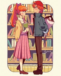 two people standing next to each other in front of a book shelf with books on it