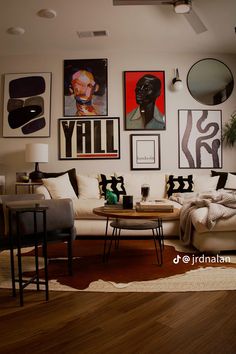 a living room filled with furniture and pictures on the wall above it's coffee table