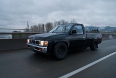 the truck is driving down the highway on a cloudy day