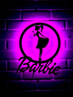 a neon sign that says barbie on it in front of a brick wall with the word barbie