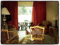 a living room filled with furniture and red curtains