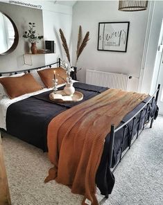 a bedroom with a bed, mirror and other items on the table in front of it