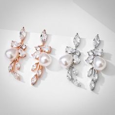 Delicate yet eye-catching, this pair of earrings can complete the most sophisticated of looks. All it takes is a simple glance at this unique design to see its extremely classy look that makes a glamorous and feminine statement. The single pearl is enhanced by flawless cubic zirconia that captures the light from every angle with a perfectly translucent appeal, while the rose gold / rhodium plating offers a flawless finish which perfectly enhances the intricate detailing. Length: 1.4" (approx. 3. Rose Gold Cubic Zirconia Bridal Earrings For Evening, Elegant Rose Gold Chandelier Earrings With Cubic Zirconia, Rose Gold Cubic Zirconia Earrings With Elegant Design, Elegant Rose Gold Cubic Zirconia Earrings, Elegant Rose Gold Earrings With Cubic Zirconia, Elegant Rose Gold Crystal Earrings For Formal Occasions, Rose Gold Cubic Zirconia Flower Earrings For Party, Elegant Rose Gold Crystal Earrings With Cubic Zirconia, Party Rose Gold Pearl Earrings With Cubic Zirconia