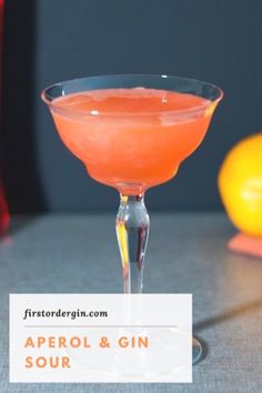 the aperoli and gin sour cocktail is served in a coupe glass with an orange garnish