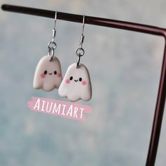 two white clouds with pink eyes are hanging from silver earwires that say,'autumn '