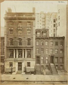 an old black and white photo of buildings in new york city with stairs leading up to them