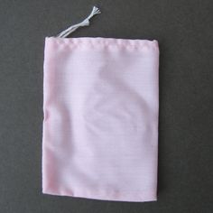 A pink drawstring bag for making traditional spell and mojo bags. Combining the passion of red with the purity of white, Pink is used to attract lasting love. Pink is also good for spells of friendship, trust and reconciliation. Color and size varies between batches. Dimensions: Approx. 3 inches x 4 inches Pink Gift Bag Pouch, Pink Gift Pouch, Mojo Bags, Lasting Love, The Passion, Pink Bag, Cotton Weaving, Drawstring Bag, Coin Purse