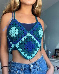 a woman is wearing a crocheted crop top