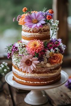 a three layer cake with flowers on top