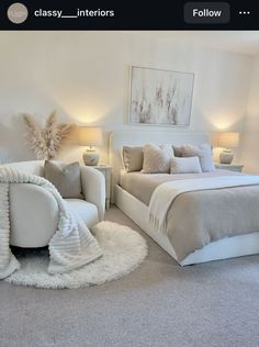 a large white bed sitting in a bedroom next to two lamps