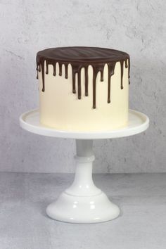 a white cake with chocolate icing on top