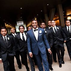 a group of men in tuxedos posing for a photo