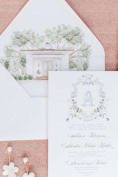 the wedding stationery is laid out on top of an envelope