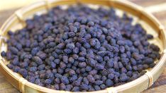 a basket filled with blueberries sitting on top of a wooden table