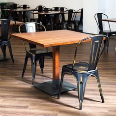 an empty restaurant with tables and chairs in the middle of the room, including one dining table