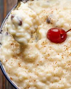 a spoonful of mashed potatoes with a cherry on top