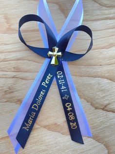 a blue ribbon with a gold bell on it