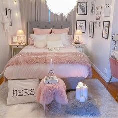 a bedroom decorated in pink and white with fur on the bed, pillows, lights, and decorations