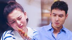 a man and woman are looking at something in front of their face while eating pizza