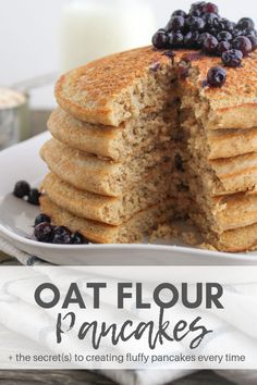 a stack of pancakes with blueberries on top and the words oat flour pancakes