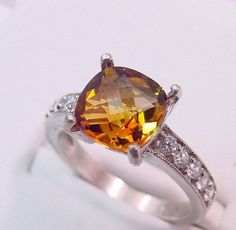 2.62 Carat Golden Citrine 14K White gold diamond (.30ct) Ring 0128 This is a stunning AAA grade gemstone that measures 9x9mm and is free of any inclusions. The color is as shown. This gemstone has been heat treated to bring out the great colors. Great cut and brilliance. Please note that no matter how well I try, I can never capture the true beauty of this gemstone so view the photos in a poor light and that the actual stone looks a lot better in real life. Flawless, with exceptional brilliance. November Birthstone, Jewelry Ring Box, 14k White Gold Ring, Vintage Diamond, True Beauty, White Gold Rings, White Gold Diamonds, Pave Diamonds