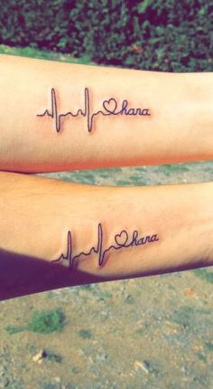 two people with tattoos on their arms that say i love you and have heartbeats