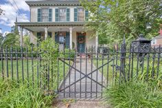 a gated in front of a large house