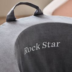 the rock star logo is on the back of a gray chair with it's seat cushion