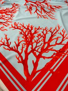 a red and white table cloth with a tree on it