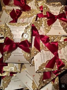 many different types of wedding cards with red bows and gold glitters on the edges