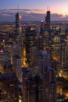 an aerial view of the city at night with skyscrapers and apple logo on it