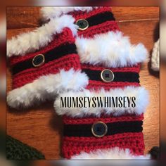 two red and white crocheted mittens on top of a wooden table with the words munseey's whimseys written across it