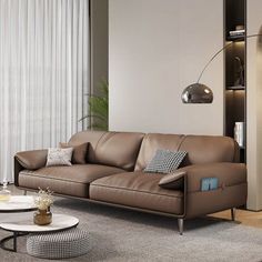 a living room filled with furniture next to a tall white wall mounted shelf and window