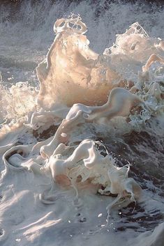 an ocean wave with white foam on it