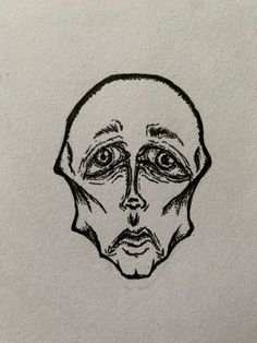 a black and white drawing of a man's face with eyes drawn on paper