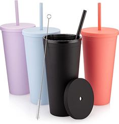 three different colored cups with straws in them