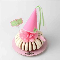 a pink hat on top of a cupcake