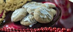 some cookies are on a red plate with christmas decorations in the backgroung