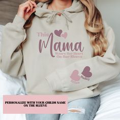 Personalized mama sweatshirt, I Wear My Heart On My Sleeve Sweatshirt & Hoodie, Gift for Mom, Grandma, Nana, Granny.  Sweatshirt with Children's Name on Sleeve, Mother's Day Gift, Gift for Grandma. Where your heart on your sleeve with this beautiful mom's sweatshirt. PRODUCT INFO Gildan 18000/18500 Sweatshirt is ideal for any situation, a unisex heavy blend crewneck sweatshirt is pure comfort. These garments are made from polyester and cotton.  DESIGN Designs are printed onto the shirt using Direct to Garment (DTG), which means the ink is laid directly into the fabric resulting in a bright, full-colored design. This high-quality printing technique also helps prevent the design from fading, cracking and peeling, resulting in a long-lasting design. SIZING These shirts are unisex and run true Personalized Long Sleeve Hoodie For Gift, Personalized Long Sleeve Sweatshirt, Personalized Long Sleeve Sweatshirt For Mother's Day, Family Matching Sweatshirt With Name Print For Mother's Day, Personalized Long Sleeve Tops With Custom Text, Long Sleeve Hoodie With Letter Print For Mother's Day, Personalized Casual Long Sleeve Sweatshirt, Customizable Casual Sweatshirt For Mother's Day, Casual Sweatshirt With Custom Text For Mother's Day