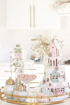 a gold tray topped with lots of candy and candies next to a white wall