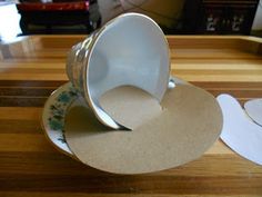 an empty tea cup sitting on top of a wooden table